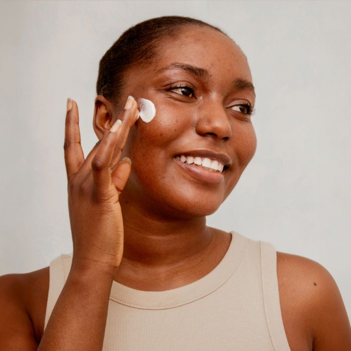 FEMME-AVEC-ACNE-QUI-APPLIQUE-DE-LA-CREME